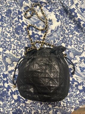 CHANEL Black Quilted Leather Drawstring Mini Shoulder Bag with Gold Chain